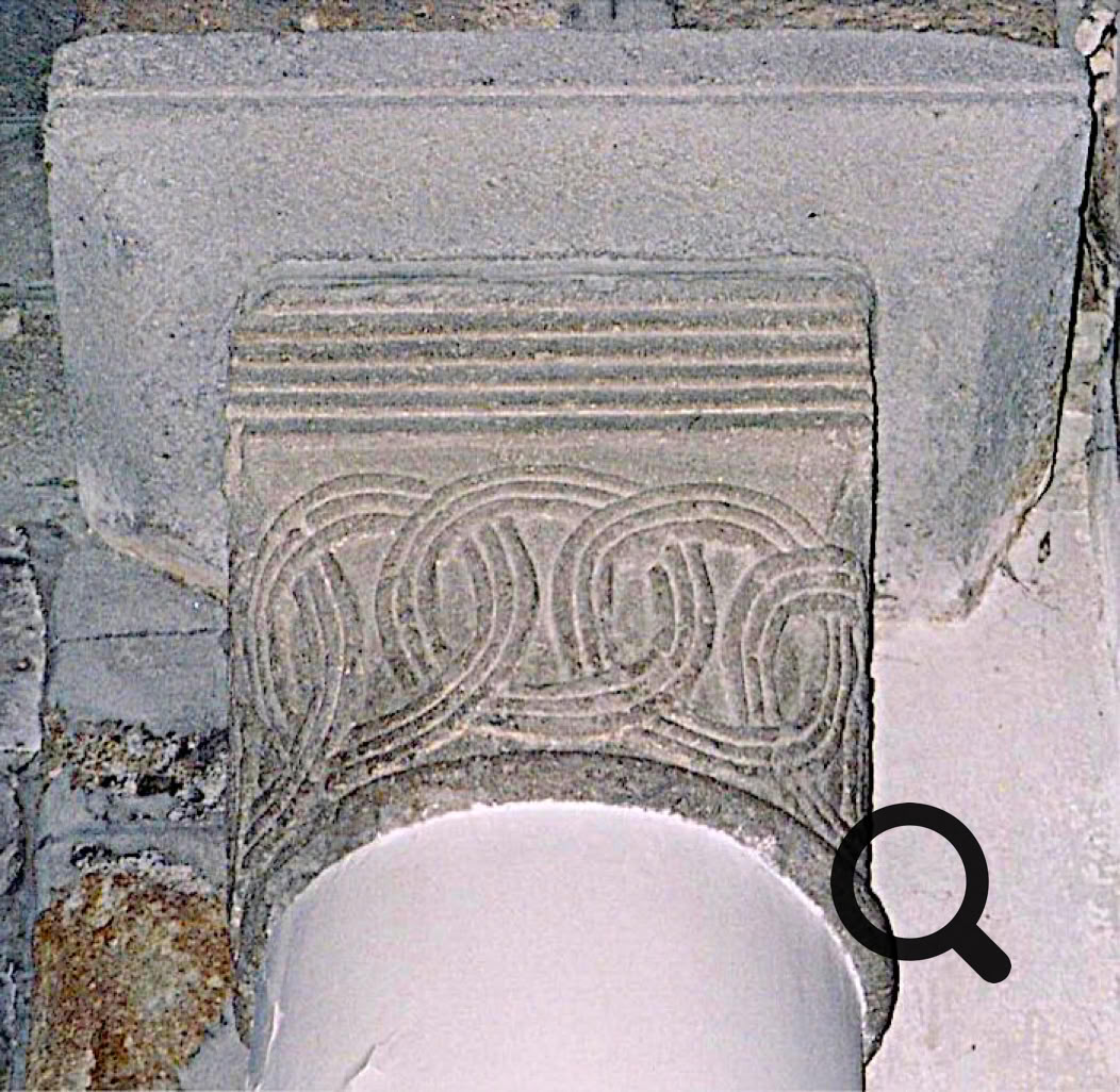 Chapiteau en pierre avec des motifs sculptés géométriques.