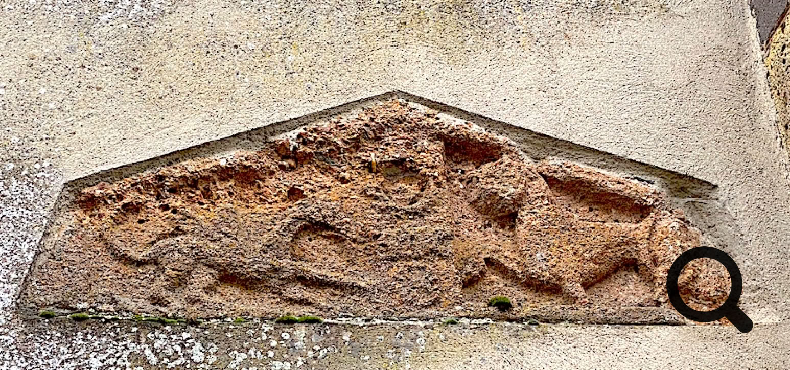 Bas-relief en pierre montrant une scène avec un lion attaquant un homme, encadré par une forme triangulaire.